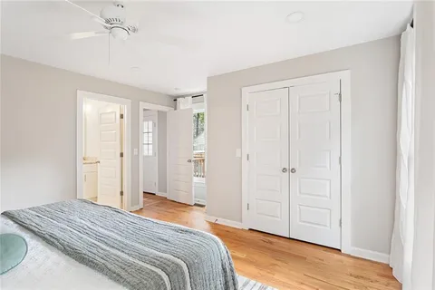 a bedroom with a bed and a chandelier fan