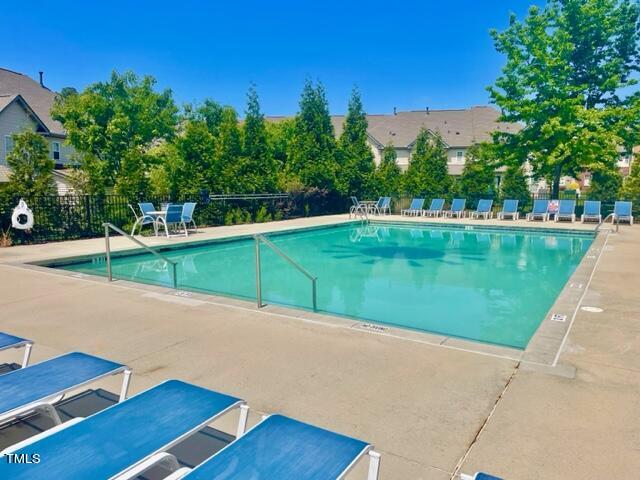9828 Layla Avenue Raleigh, NC 27617 - Photo 20 of 21 a view of a swimming pool with a yard