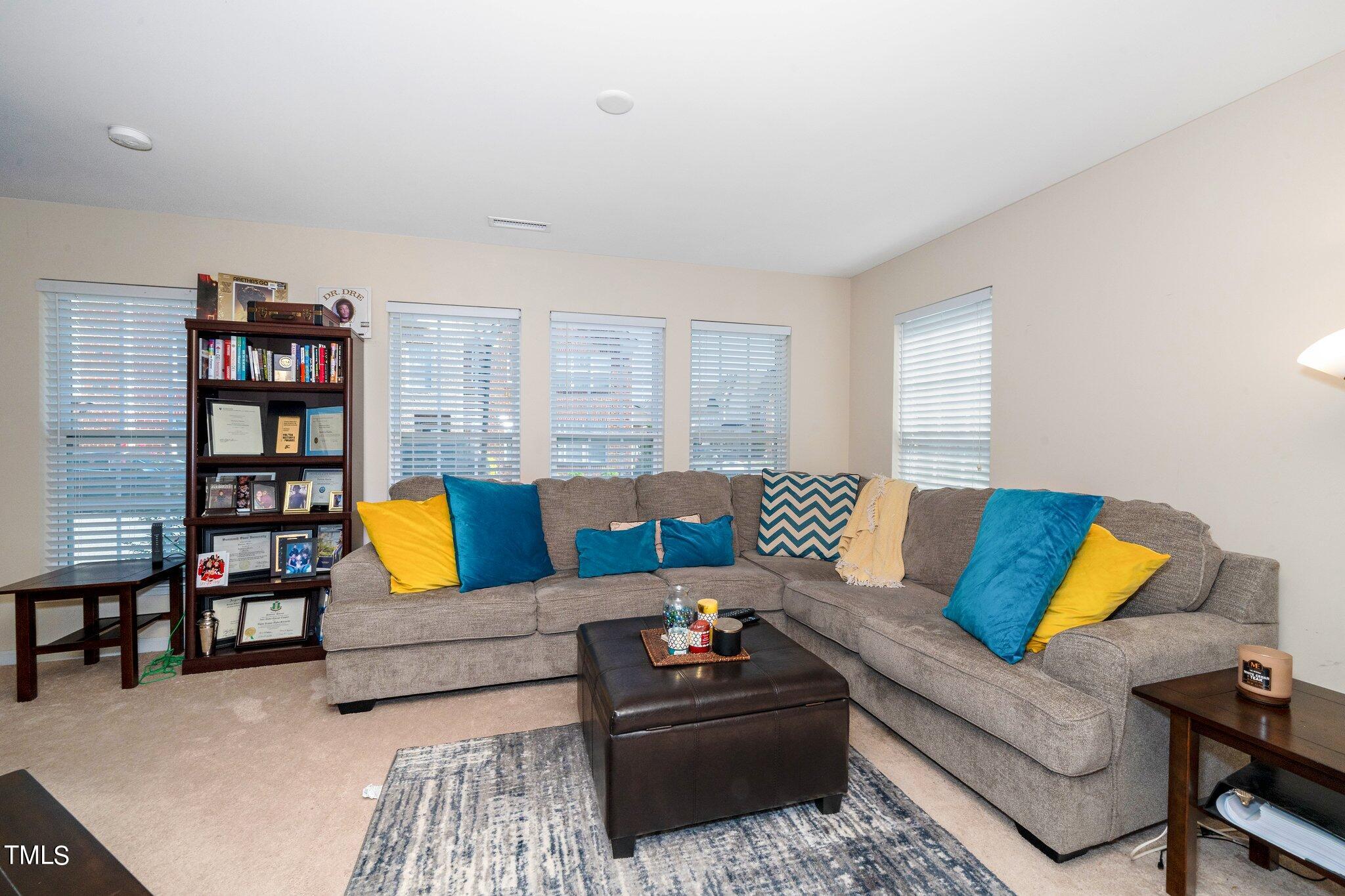 9828 Layla Avenue Raleigh, NC 27617 - Photo 5 of 21 a living room with furniture and a book shelf