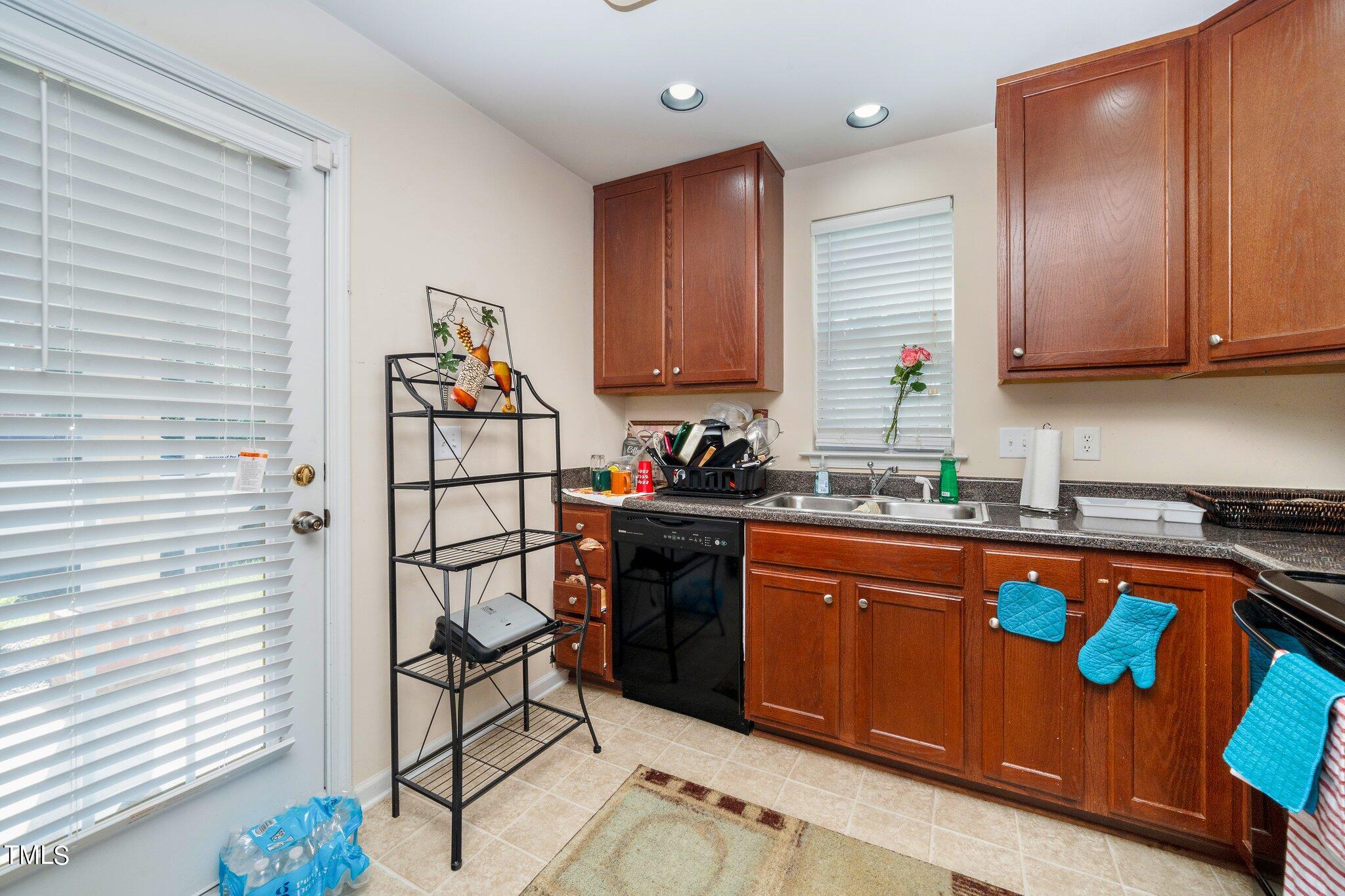 9828 Layla Avenue Raleigh, NC 27617 - Photo 8 of 21 a kitchen with stainless steel appliances granite countertop a stove a sink dishwasher and cabinets with wooden floor