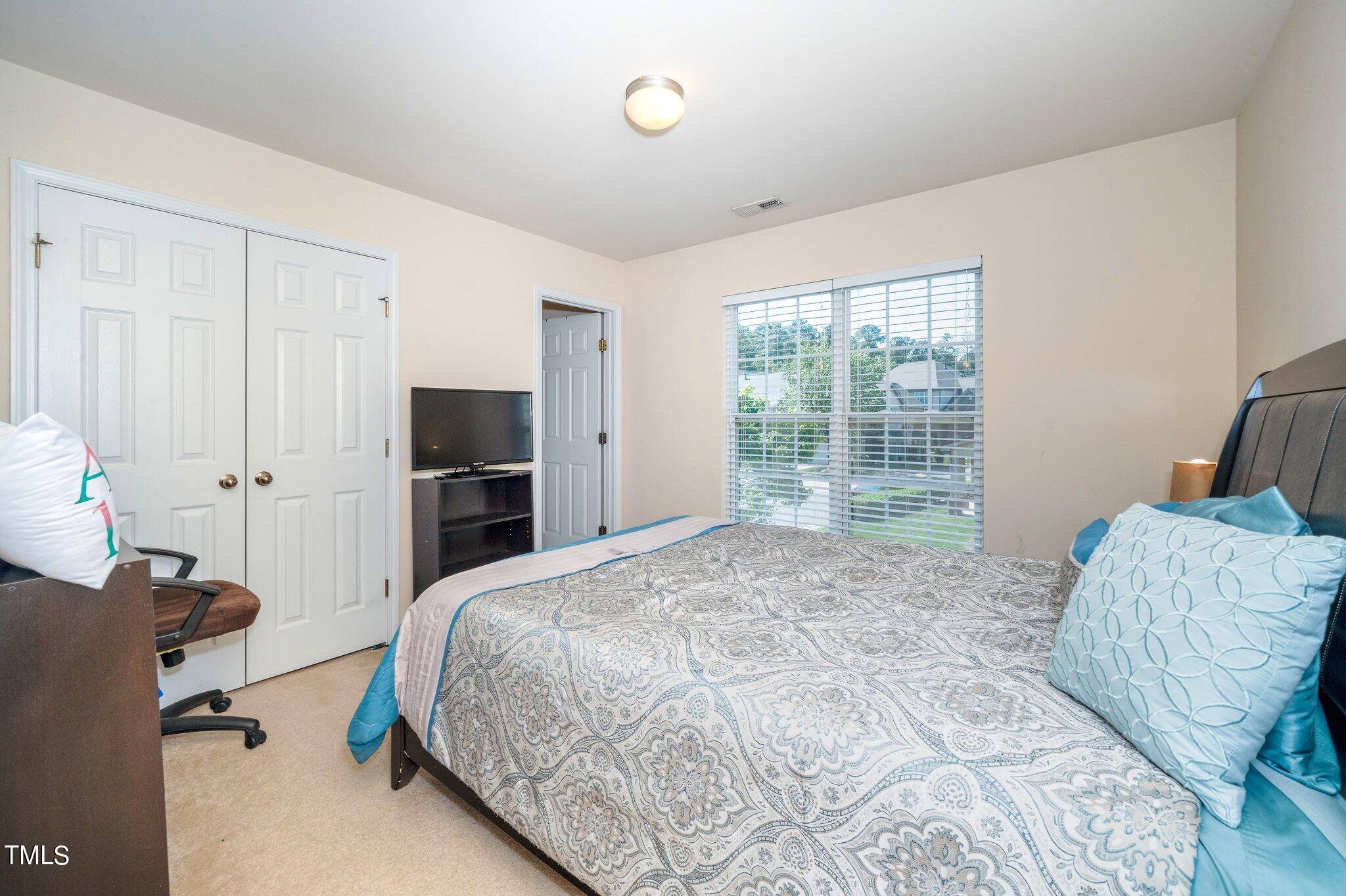 9828 Layla Avenue Raleigh, NC 27617 - Photo 10 of 21 a bedroom with a bed and a window