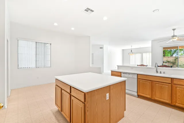 a kitchen that has a sink a stove and a table in it
