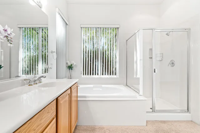 a bathroom with a tub sink and mirror