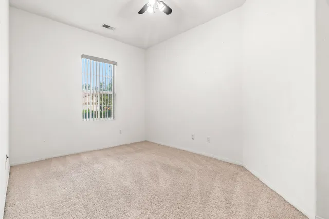 an empty room with a empty space and windows