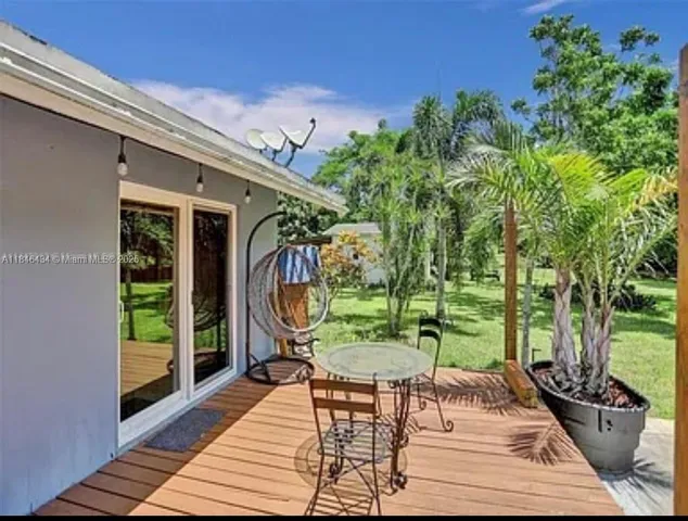 a backyard of a house with barbeque oven table and chairs