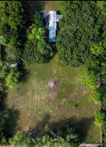 a view of a house with a yard and potted plants