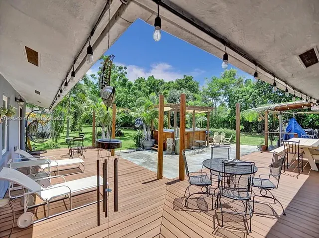 a view of a house with backyard sitting area and garden
