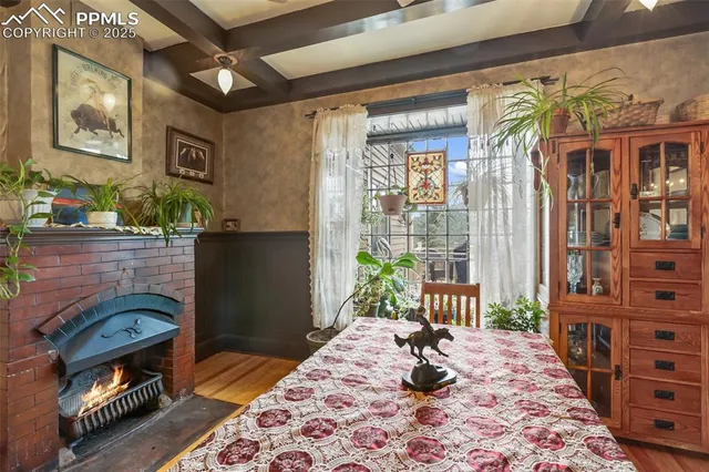 a bedroom with a bed a dresser and next to a window