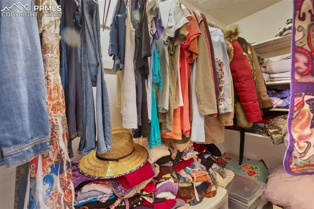 a bed and a couch in a bedroom next to a window