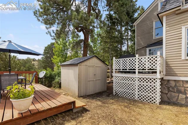 a view of a balcony with wooden floor and fence