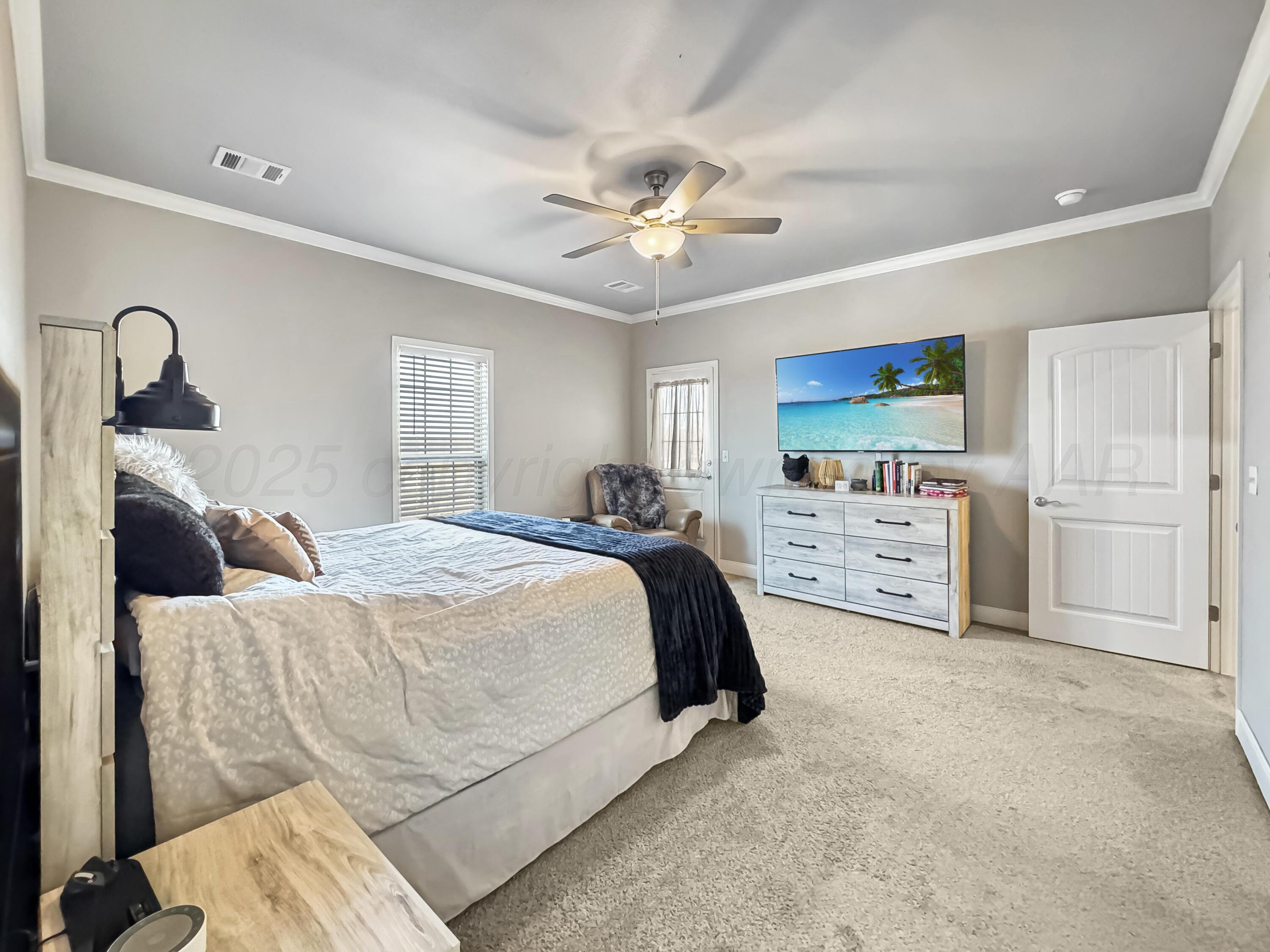 18300 Taurus Trail Canyon, TX 79015 - Photo 11 of 32 a spacious bedroom with a bed and a flat screen tv