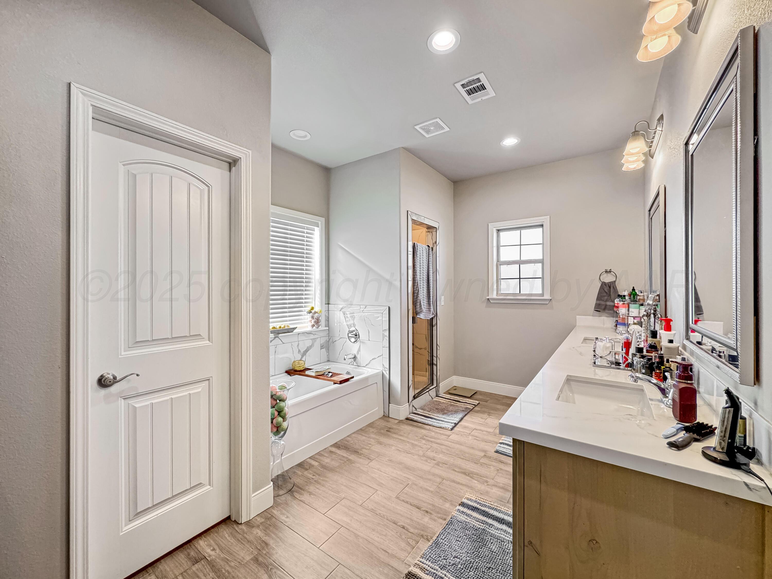 18300 Taurus Trail Canyon, TX 79015 - Photo 13 of 32 a bathroom with sink a mirror and a shower