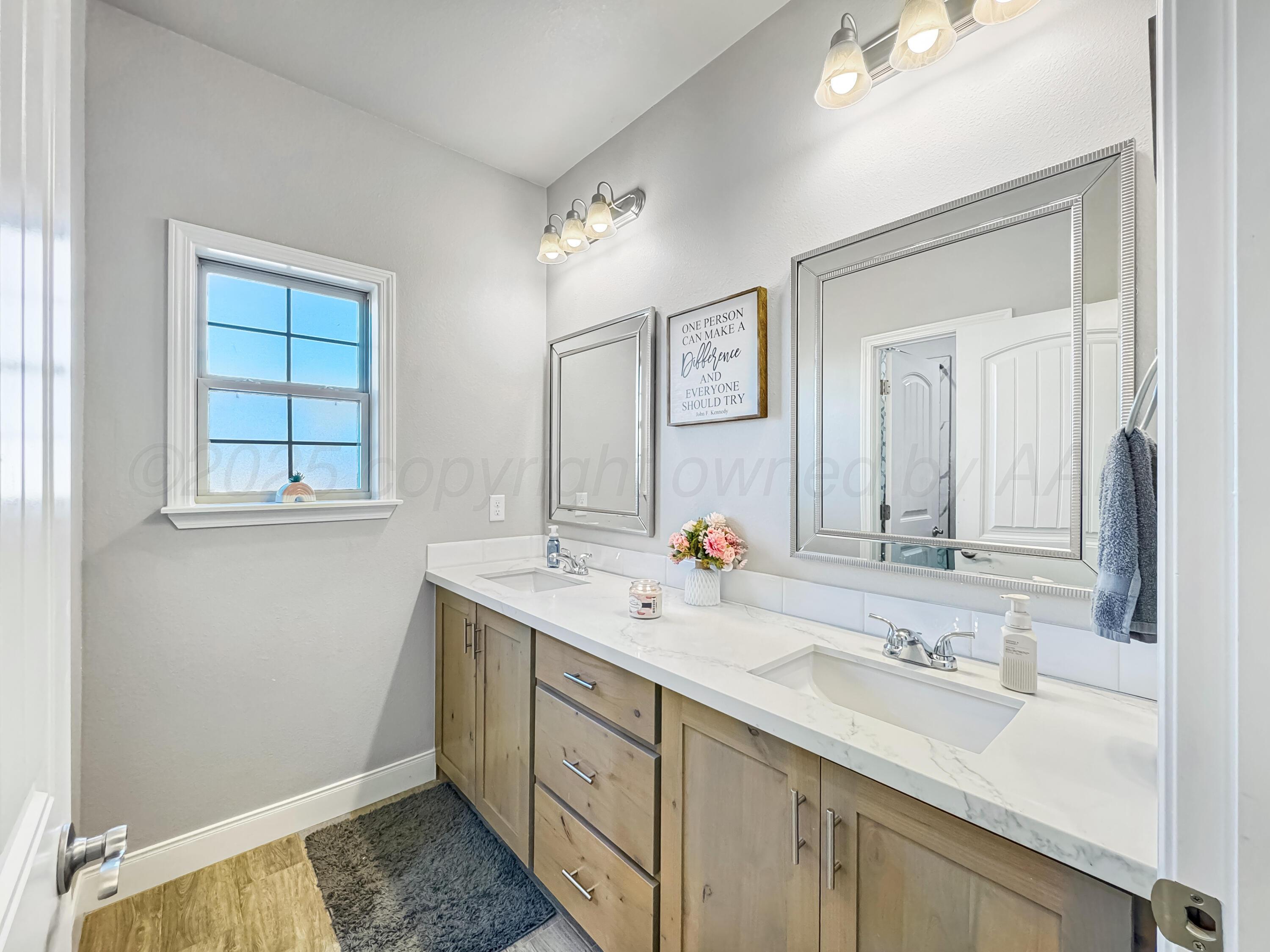 18300 Taurus Trail Canyon, TX 79015 - Photo 20 of 32 a bathroom with a sink and a mirror