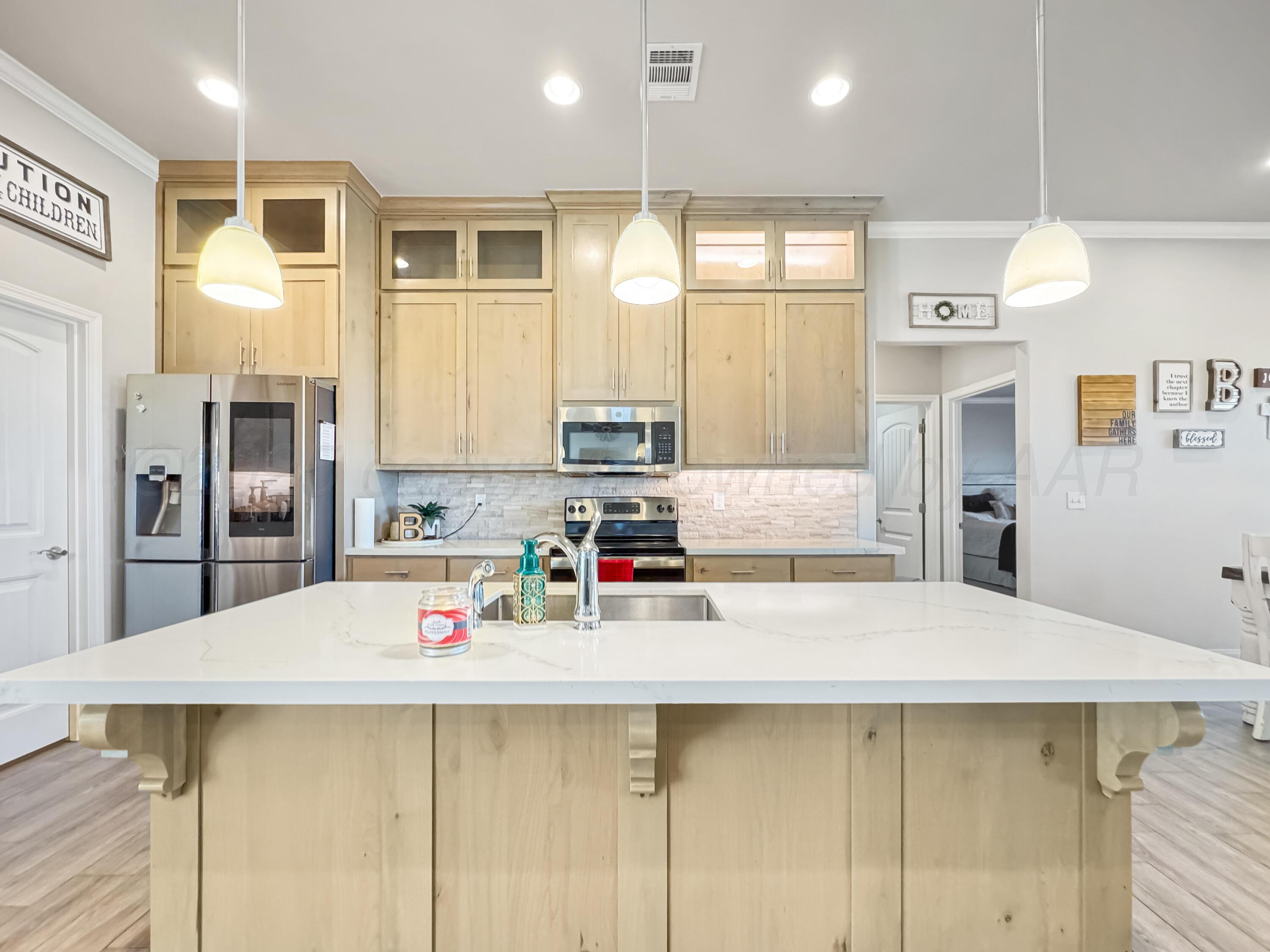 18300 Taurus Trail Canyon, TX 79015 - Photo 4 of 32 a kitchen with counter top space cabinets and refrigerator