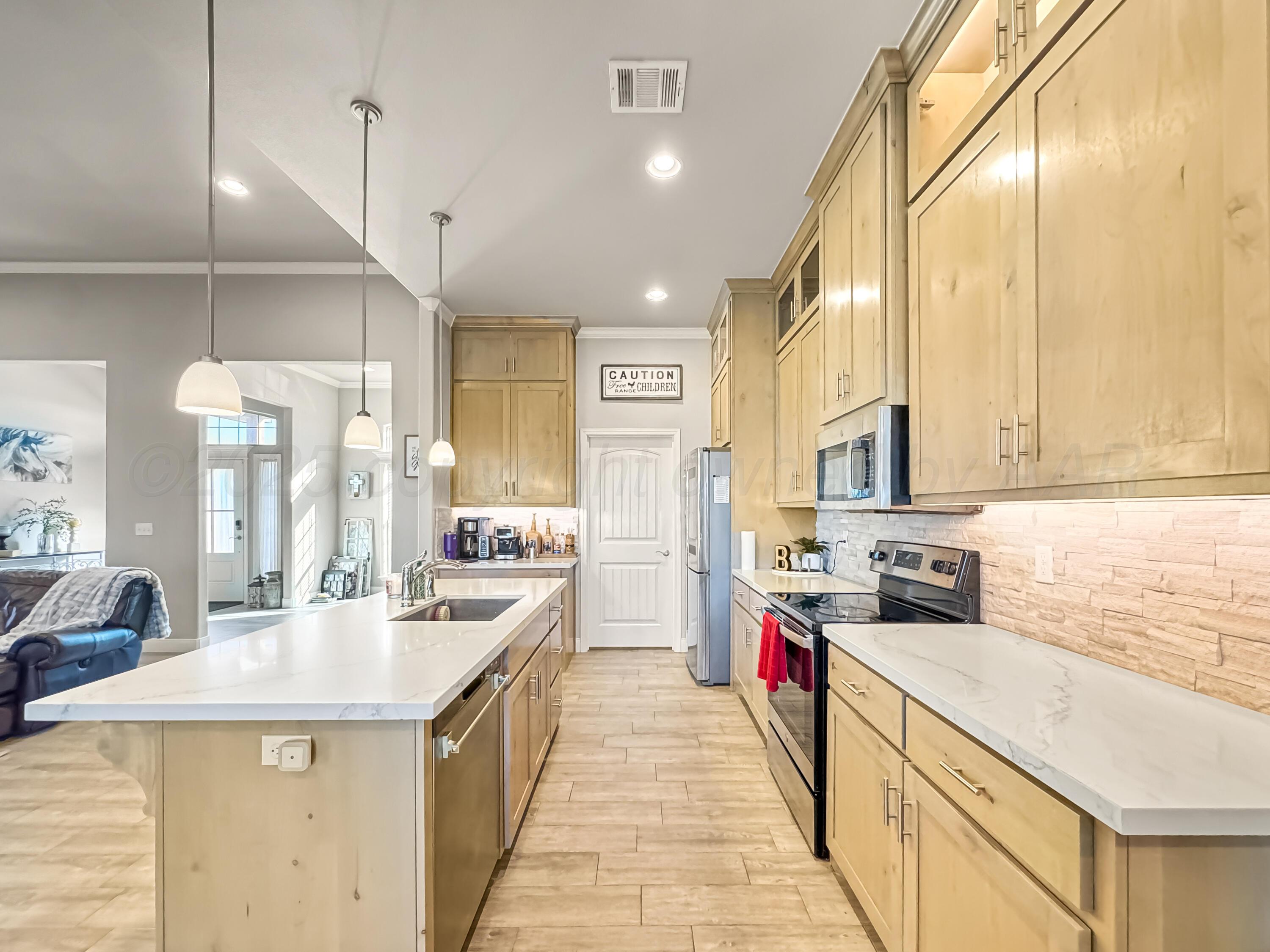 18300 Taurus Trail Canyon, TX 79015 - Photo 5 of 32 a large kitchen with stainless steel appliances a sink and cabinets