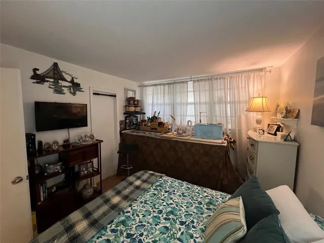 a kitchen with a refrigerator and a stove top oven