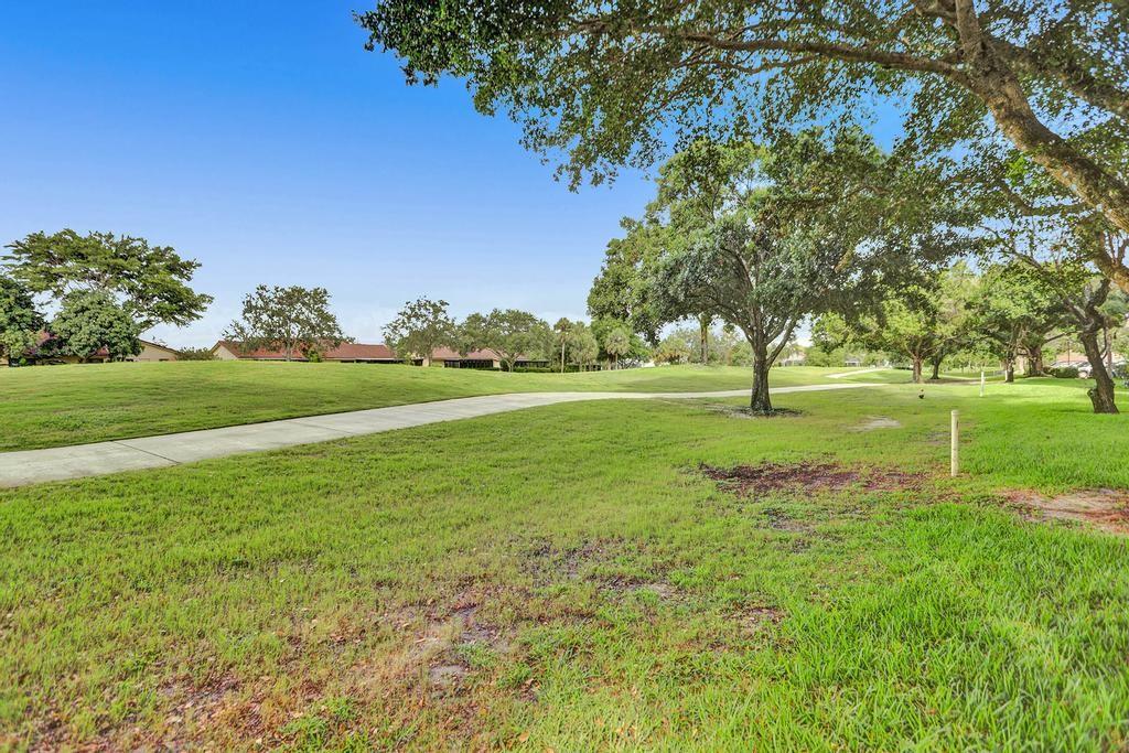 9520 Seagrape Drive, Unit 103 Davie, FL 33324 - Photo 17 of 39 a view of a golf course with a garden