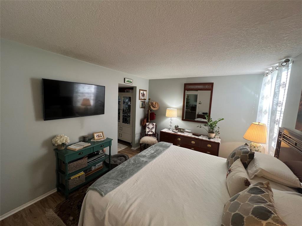 9520 Seagrape Drive, Unit 103 Davie, FL 33324 - Photo 8 of 39 a bedroom with a bed and a flat screen tv