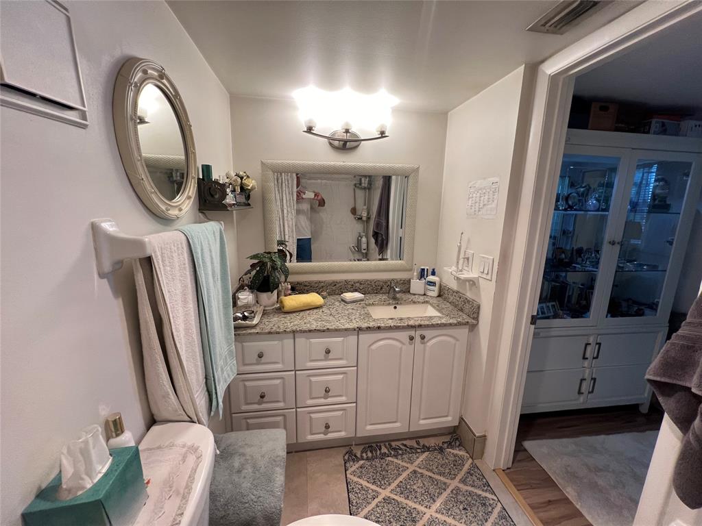 9520 Seagrape Drive, Unit 103 Davie, FL 33324 - Photo 10 of 39 a bathroom with a double vanity sink and a mirror