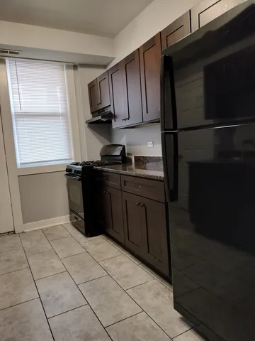 a kitchen with stainless steel appliances granite countertop a sink and a stove