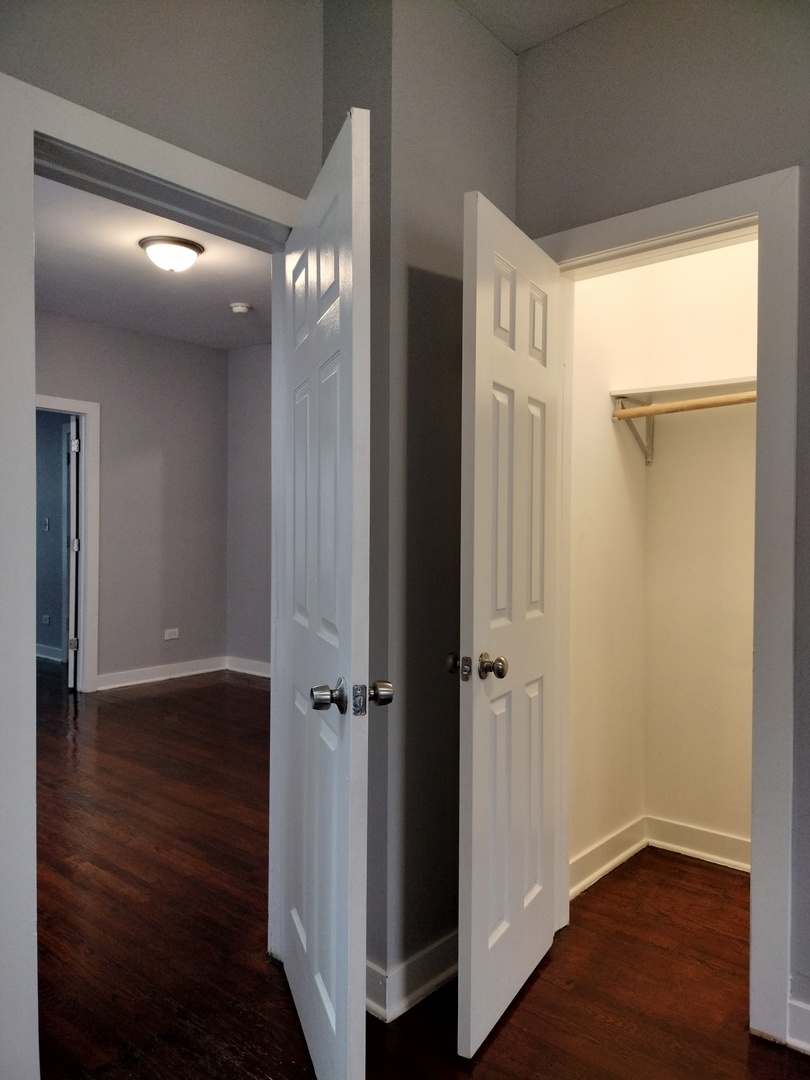6603 South Bishop Street, Unit 66032 Chicago, IL 60636 - Photo 15 of 19 an empty room with wooden floor and a window