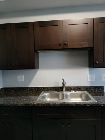 a kitchen with a sink and cabinets
