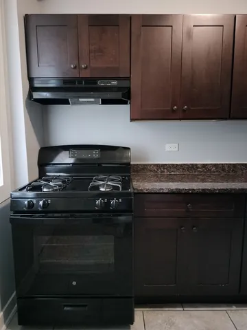 a stove top oven sitting inside of a kitchen