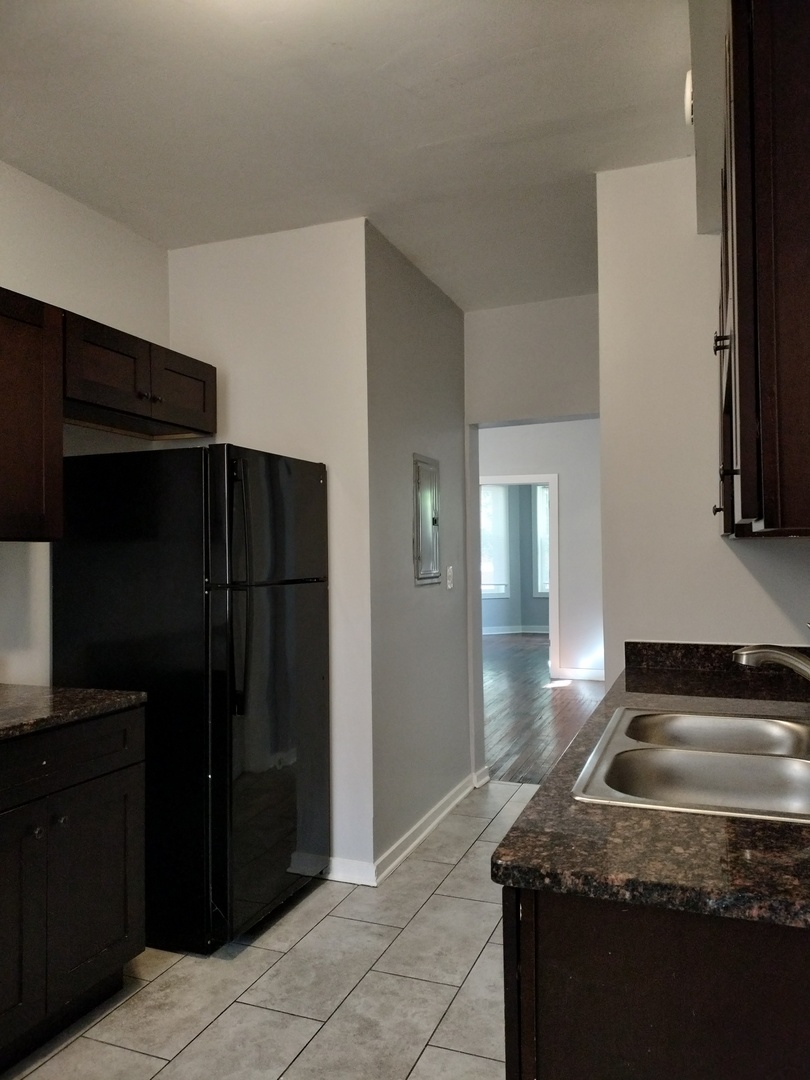 6603 South Bishop Street, Unit 66032 Chicago, IL 60636 - Photo 7 of 19 a kitchen with a refrigerator and a sink