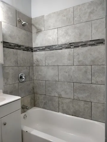 a bathroom with a bathtub and shower