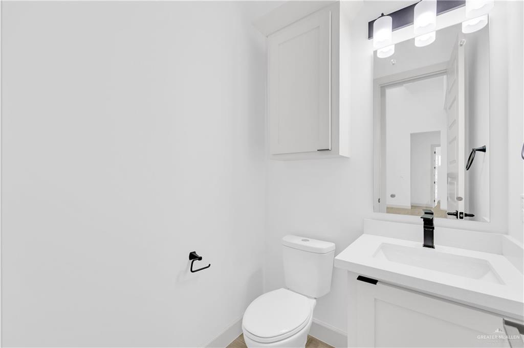 1515 Duke Street Mission, TX 78572 - Photo 11 of 33 a white toilet sitting next to a bathroom sink