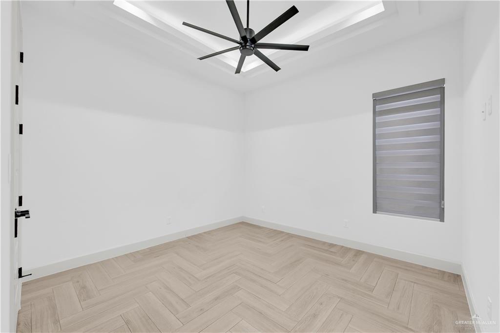 1515 Duke Street Mission, TX 78572 - Photo 12 of 33 an empty room with a window and a fan
