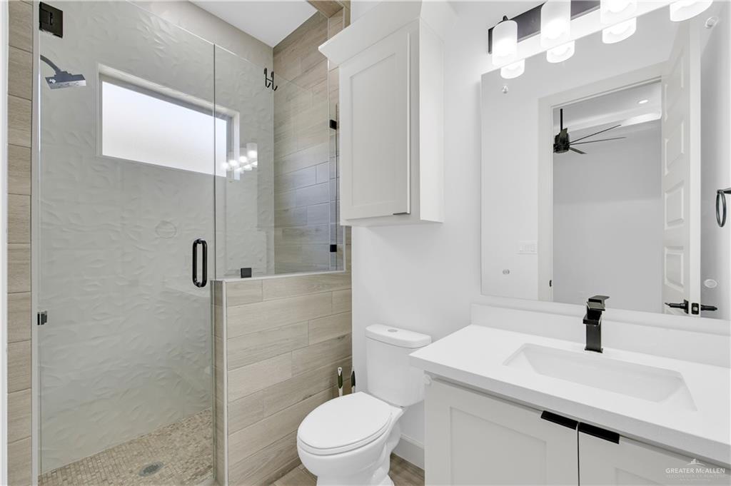 1515 Duke Street Mission, TX 78572 - Photo 13 of 33 a bathroom with a sink a toilet and shower