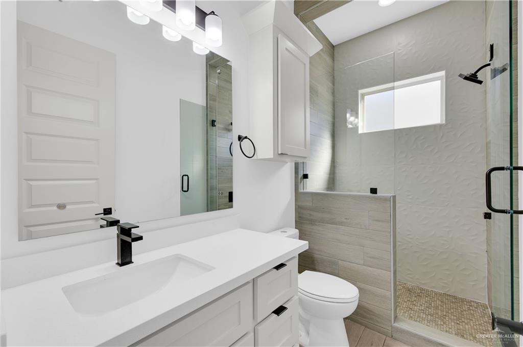 1515 Duke Street Mission, TX 78572 - Photo 15 of 33 a bathroom with a sink a toilet and shower