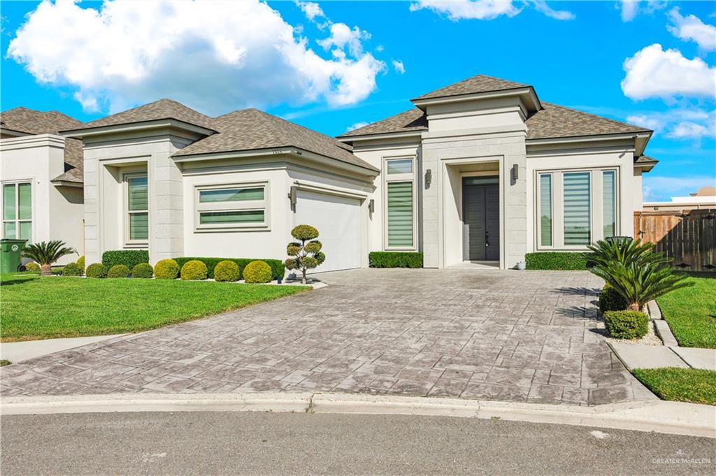1515 Duke Street Mission, TX 78572 - Photo 2 of 33 a front view of a house with a yard and garage