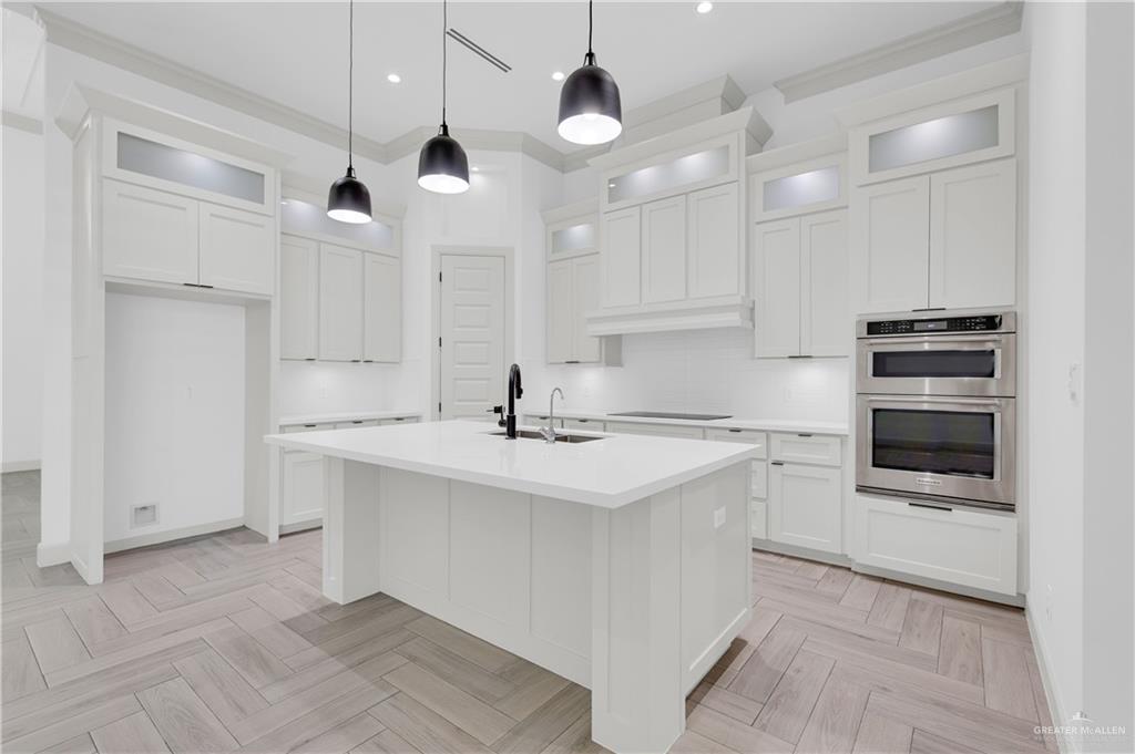 1515 Duke Street Mission, TX 78572 - Photo 8 of 33 a kitchen with a sink stainless steel appliances and cabinets