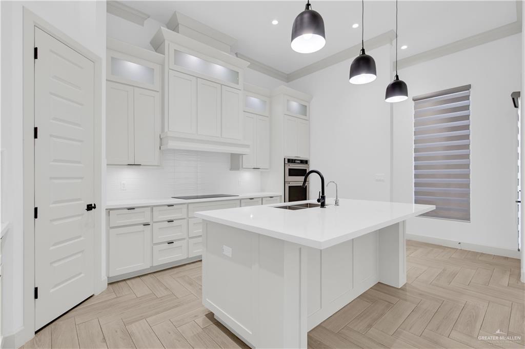 1515 Duke Street Mission, TX 78572 - Photo 9 of 33 a kitchen with a stove a sink and a refrigerator