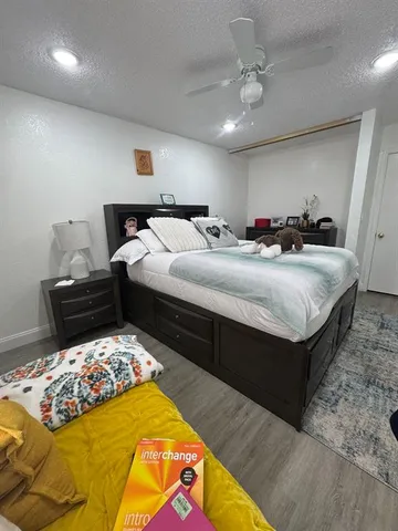 a bedroom with bed and a chandelier