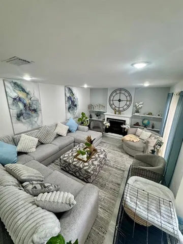 a living room with furniture or couch and a large mirror