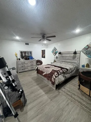 a spacious bedroom with a bed and a couch