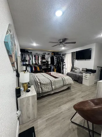 a bed room with furniture and a wooden floor