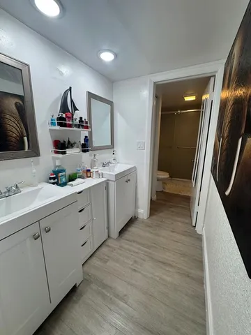 a spacious bathroom with a double vanity sink and a mirror