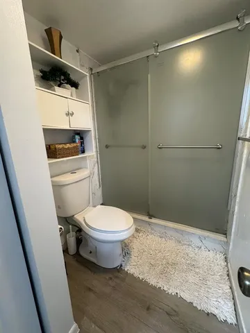a bathroom with a toilet a sink and shower