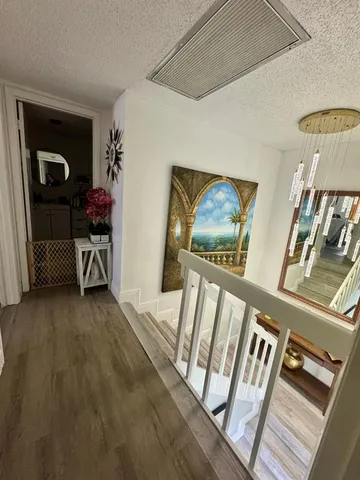 a view of a hallway with furniture and front door