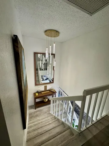a view of entryway with stairs and wooden floor
