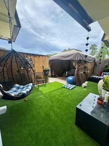 a view of a backyard with sitting area