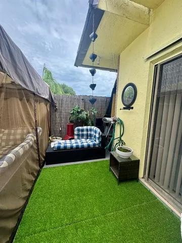 a view of a backyard with sitting area
