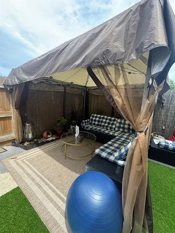 a view of a backyard with sitting area