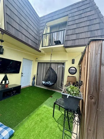 a front view of a house with garden and patio