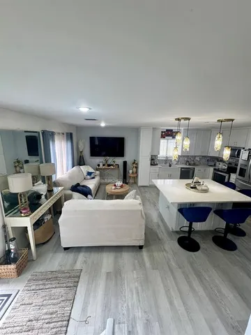 a living room with furniture flat screen tv and a window