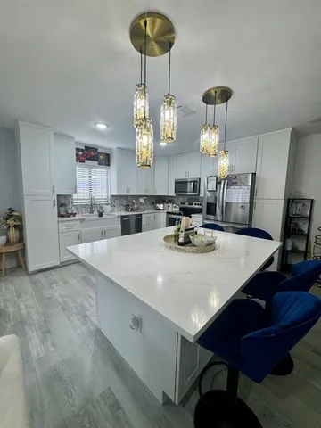 a large kitchen with a table and chairs
